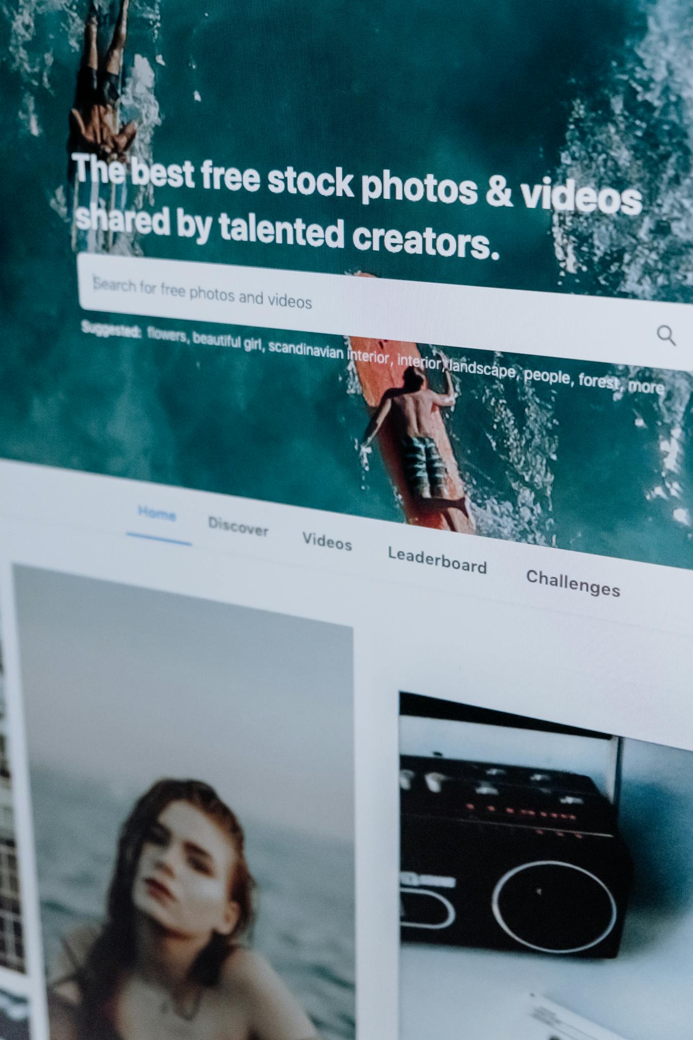 Close-up of a computer screen showing a stock photo website interface with multiple images.