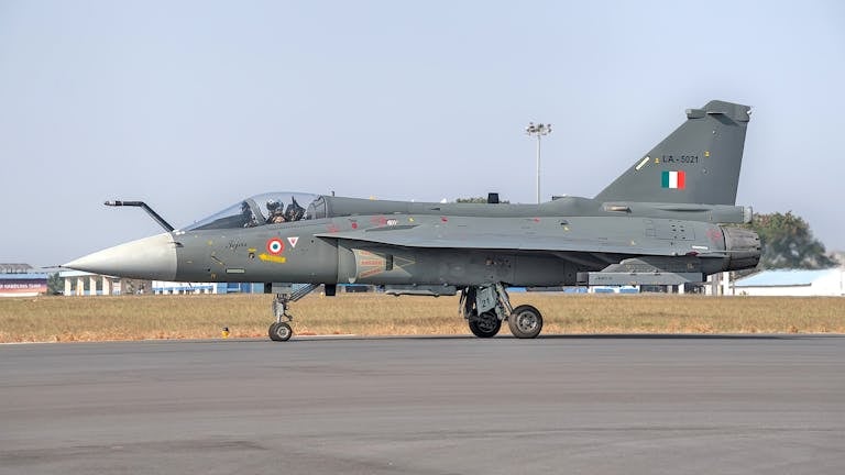 Tejas fighter jet of Indian Air Force parked on runway.